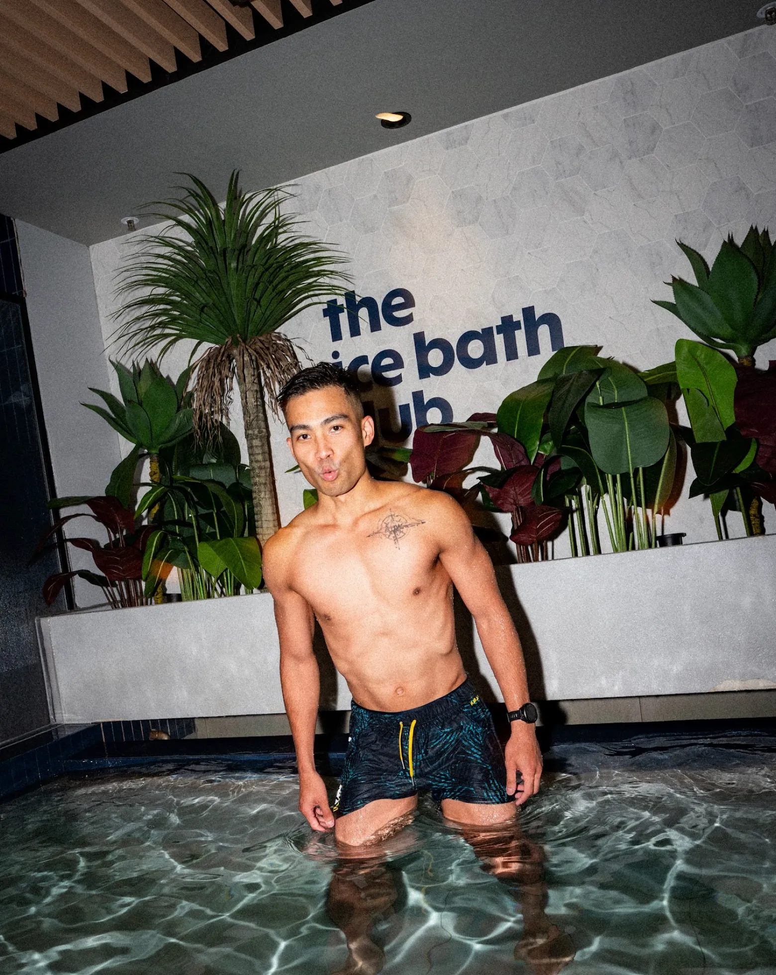 A member standing waist-deep in the ice bath