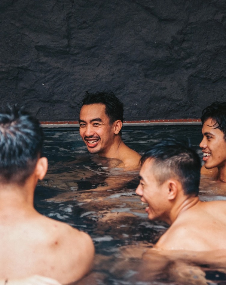 Members laughing together in the bath